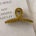 Mustard yellow flocked cross hair claw clip for women on a vintage book backdrop - Ginger Yellow