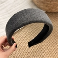 Close-up of thick dark grey wool-textured sponge headband with black non-slip inner lining - Gray