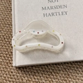 Close-up of cream white translucent hair claw clip with colorful mini rhinestones - Semi-Circle Claw