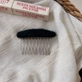 Close-up of a 10-tooth metal hair comb with black plush wool top on linen background - Dark Ink Green