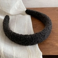 Detailed close-up of dark grey thick faux fur headband with fluffy lamb wool texture - Black