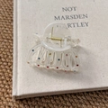 Close-up of clear acrylic star hair claw clip with colorful rhinestones on a book - Irregular Geometry Claw Clip