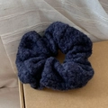 Detailed texture of fluffy purple knit scrunchie on brown paper packaging background - Dark Blue