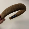 Macro shot of brown wool texture and 'HAND MADE' label on a warm winter headband - Yellow Coffee Headband