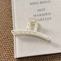 Detail of arc hair claw clip with colorful rhinestones on beige acetate material - Straight Claw