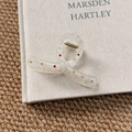 Detail of transparent acrylic hair claw clip featuring colorful rhinestones and gold spring - Small Cross Claw Clip