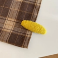 Detailed close-up of yellow plush oval hair clip with textured wool fabric surface - Oval / Yellow