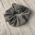 Detailed close-up of dark grey ribbed knit scrunchie featuring a white Hand Made label - Light Gray