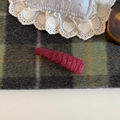 Detailed view of burgundy knit hairpin texture with warm winter wool fiber weave - Red