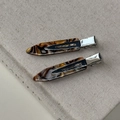 Macro detail of tortoiseshell acetate hair clips with France Handmade silver metal base - Coffee Gradient