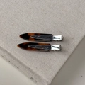 Detail of tortoise shell hair clips with silver metal base on a linen book surface - Dark Tortoiseshell