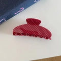 Macro detail of red hair claw clip with white polka dots on denim background - Red Polka Dot