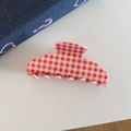 Detail view of red and white gingham acetate hair claw clip on denim background - Red White Plaid
