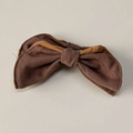 Detail of a brown bow hair clip showing twill fabric texture and dual-tone stitching - Yellow Coffee Banana Clip