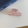 Detail of lavender checkered acetate claw clip featuring 3D white flowers and small rhinestones - Pink Grid