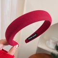 Close-up of burgundy ribbed knit headband featuring a handmade label on the inner band - Knitted Headband