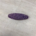Close-up of purple herringbone tweed oval hair clip on textured beige linen fabric - Plaid Purple Oval