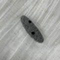 Detail of gray felt hair clip featuring minimalist black polka dots on soft fabric - Grey Oval