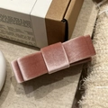 Close-up of a dusty pink velvet bow hair clip showing soft fabric layers and texture - Pink