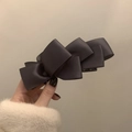 Detailed view of the layered satin ribbon bow on the dark vertical banana hair clip - Space Purple