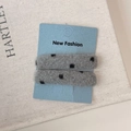 Set of two gray felt hair clips with black polka dots on a blue fashion display card - Gray Polka Dot Rectangle