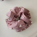 Close-up of pink satin scrunchie with beaded edges and ruffled texture detail - Pink
