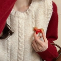 Detail of red Songjin silk horse brooch with gold embroidery on beige knit vest - Red