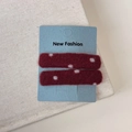 Close-up of burgundy red polka dot hair clips on display card with soft velvet texture - Red Polka Dot Rectangle