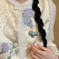 Detailed close-up of embroidered Song brocade vest with faux fur trim and horse brooch - Blue