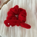 Detail of red plush festive scrunchie with cute pearl accents on soft fabric - Red Bow Scrunchie