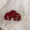 Detailed close-up of dark red resin hair claw with golden Barrette La France text - Red Curved