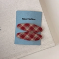 Detail view of red argyle wool fabric BB hair clips for women on New Fashion card - Checkered Oval