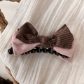 Close-up of a striped bow hair clip featuring pink faux suede and brown striped fabric - Pink Flower Banana Clip
