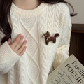 Close-up of a brown embroidered horse brooch with red plaid saddle on white sweater - Brown Bow Pony