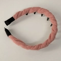 Detail showing the pink cable-knit fabric and black non-slip inner teeth of the headband - Pink