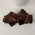 Detail of a large dark brown plaid fabric bow hair claw clip for elegant hairstyles - Chestnut Check