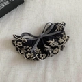 Detailed macro view of vintage floral embroidery and grey bow on a premium banana clip - Gray with Bowknot
