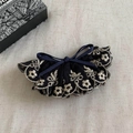 Close-up of vintage navy blue lace embroidery hair clip with elegant floral stitching - Navy Blue Bow