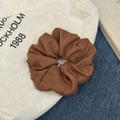 Minimalist dark brown suede scrunchie with soft fabric texture and pleated design - Brown