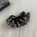 Close-up of black lace bow hair clip with white floral embroidery and black bead detail - Black Bow