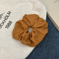 Detail of dark brown faux suede scrunchie showcasing the soft matte fabric texture - Pumpkin Orange