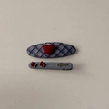 Detailed view of grey plaid fabric hair clips set with red hearts and Always lettering - Blue Gray Plaid Heart Hair Clip Pair