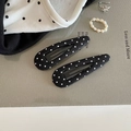 Close-up of black and white polka dot fabric BB hair clips with classic metal structure - Black Hollow Teardrop