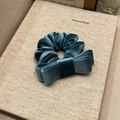Detail showing the peacock blue velvet fabric texture on a double-layer bow hair scrunchie - Lake Blue