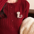 Détail du pull en maille torsadée rouge avec une broche alpaga en peluche et broderie étoile - Style Alpaga Beige