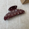 Detail of dark reddish-brown hair claw clip with sweet pink butterfly patterns - Brown Fan Shape