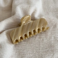 Elegant beige tortoiseshell acetate hair claw clip on linen fabric background - Milk Coffee