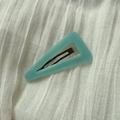 Macro shot of mint green geometric hair clip with France Handmade text on fabric - Light Blue