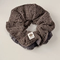 Macro detail of dark grey knit scrunchie with lace texture and polka dot lining - Waisted Scrunchie / Brown