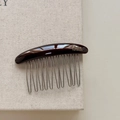 Macro shot of dark brown resin hair comb with handmade golden lettering and metal teeth - Chocolate Brown